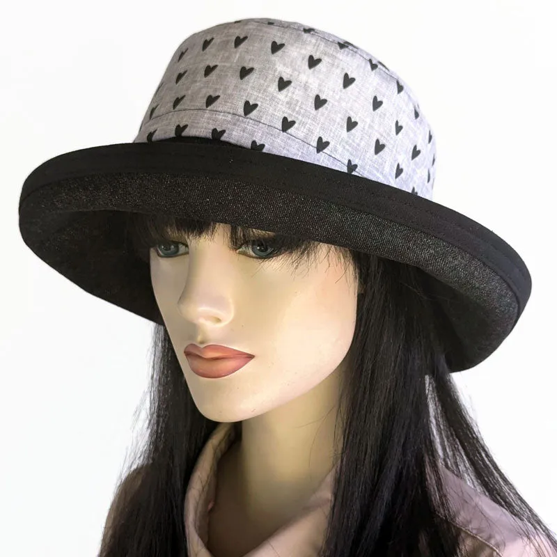 Sunblocker UV sun hat with wide brim, featuring black hearts on grey with black denim brim