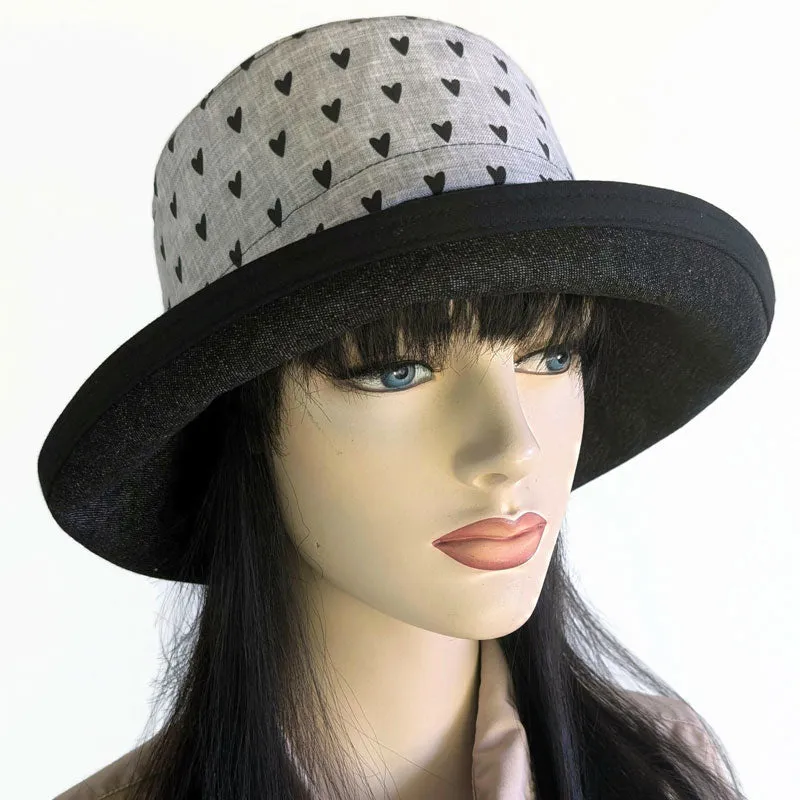 Sunblocker UV sun hat with wide brim, featuring black hearts on grey with black denim brim